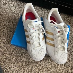 Gold and white shell-toe adidas